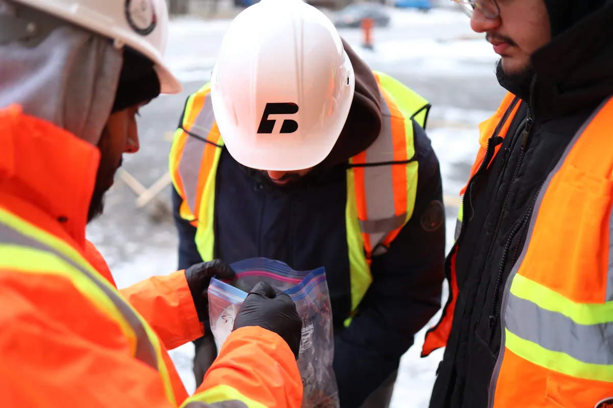 Field staff examining a recovered soil sample on site