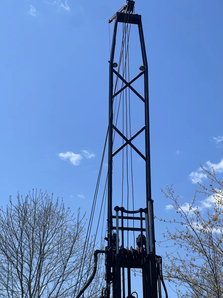 Drill mast against open sky in spring