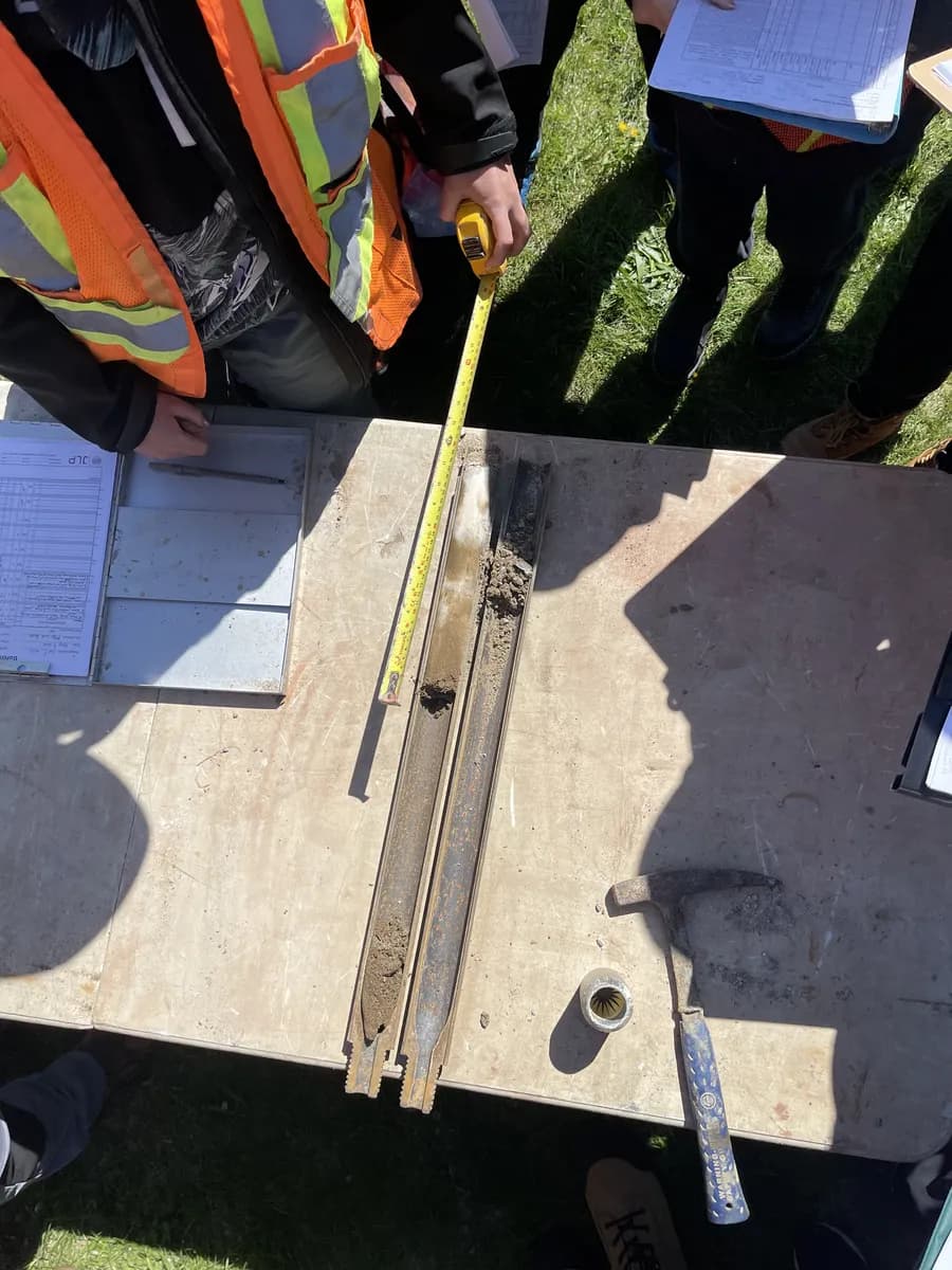 Split spoon samplers opened and measured on plywood